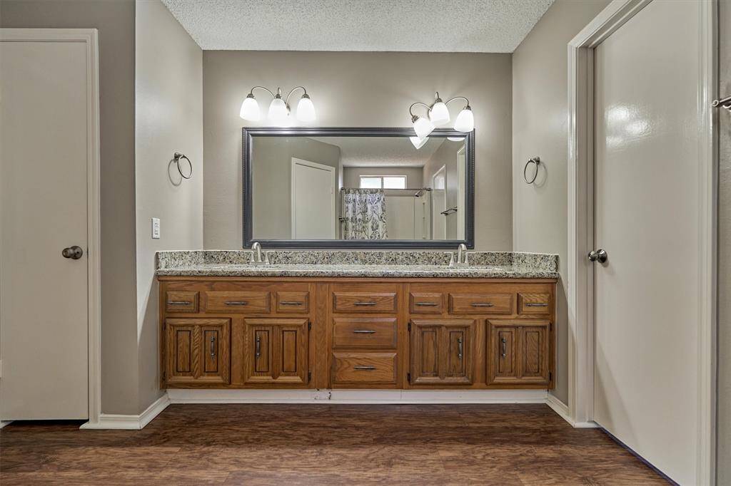 Large primary bathroom with overhead lighting