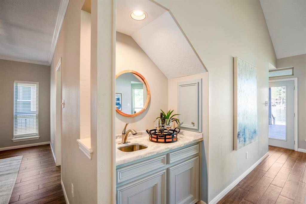 The wet bar has been completely styled with marble and updated lighting and offers a place to serve cocktails.