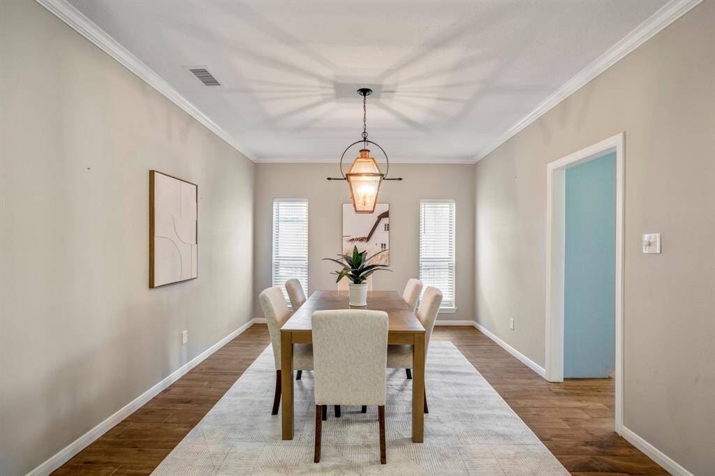 Beautiful updated lighting reflect into a large light and bright formal dining room that is also relaxed and functional.