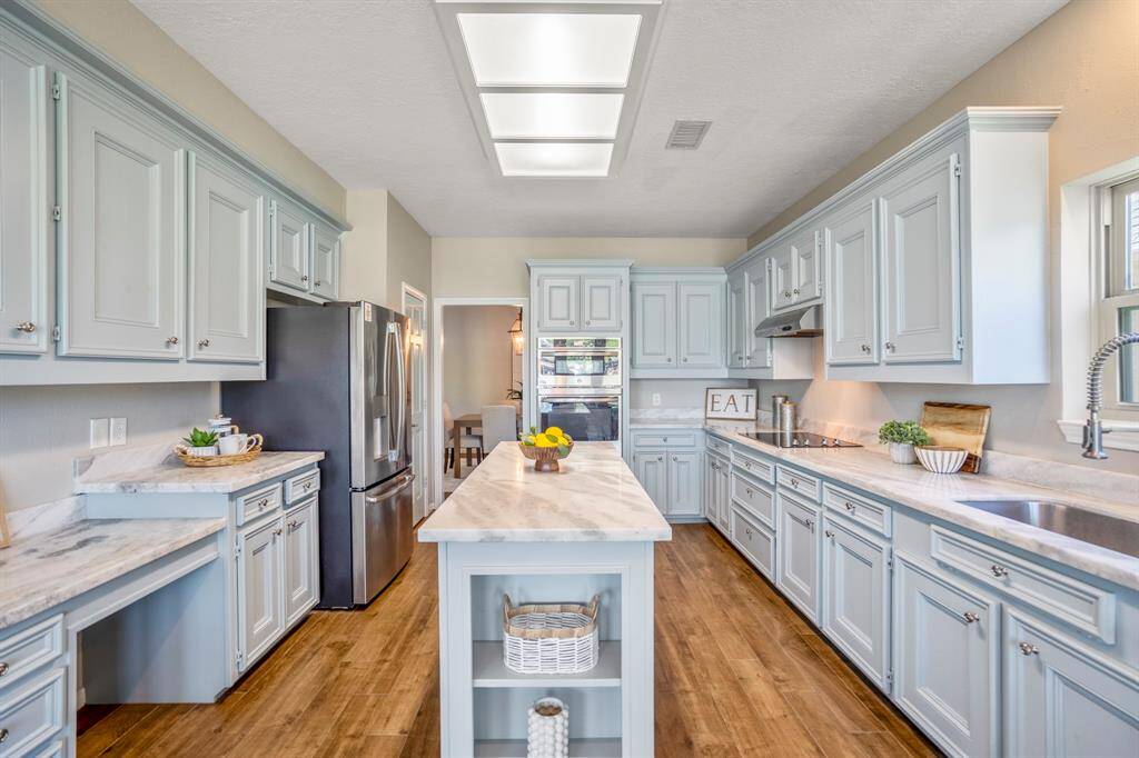 Completely updated and featuring functional stainless steel appliances, sink, hardware and a stove top.