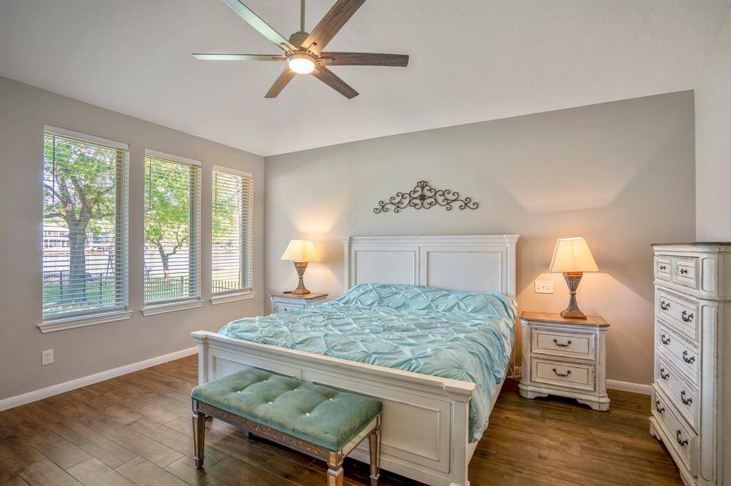 The primary bedroom is spacious and has 3 large windows that offer lovely views of Lake Conroe.