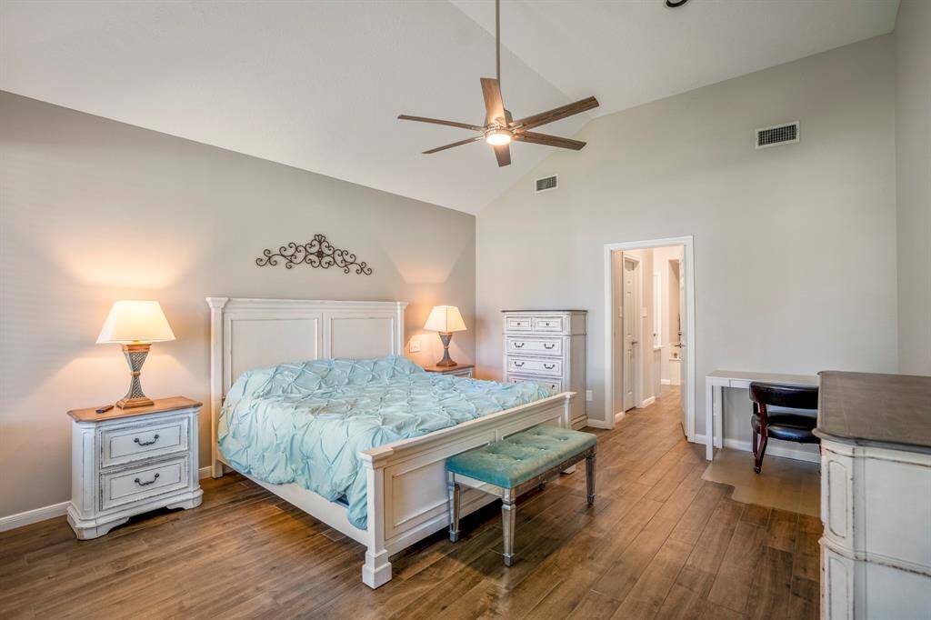 The primary bedroom is huge and easily accommodates large furniture and a seating area.