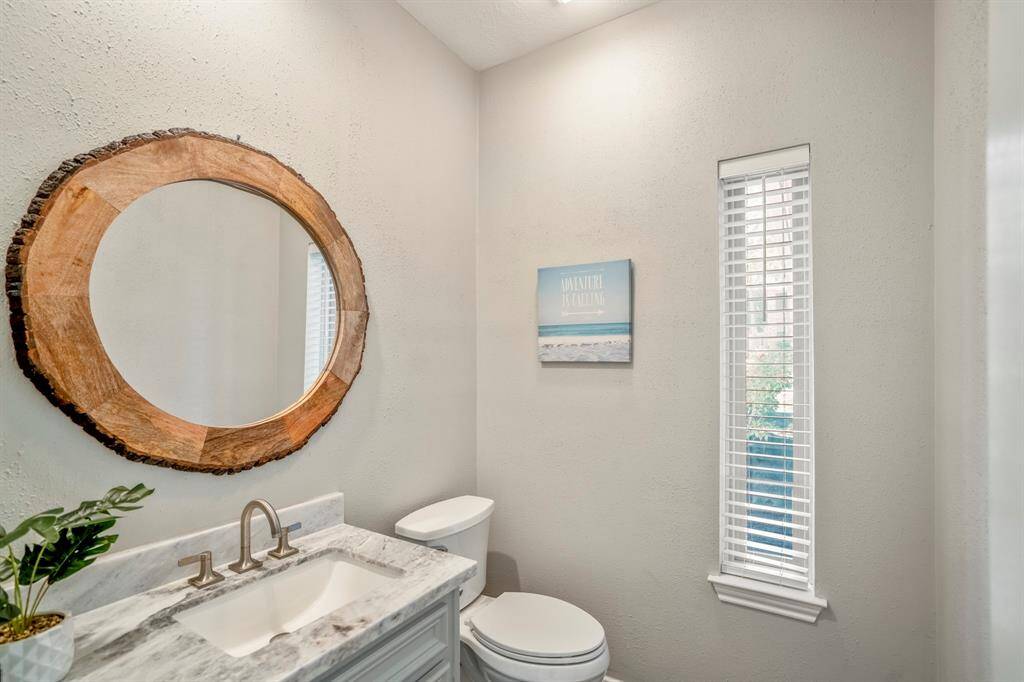 The half bathroom offers your guests convenience and is freshly painted with updated hardware and marble top vanity.