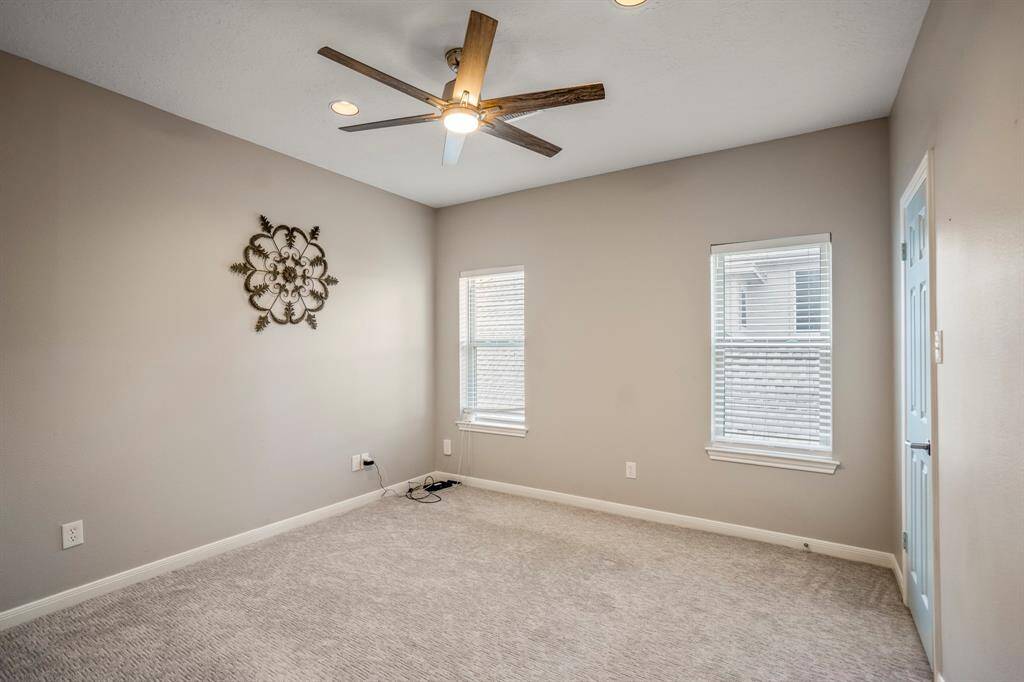 Another secondary bedroom offers neutral tones and large windows, as well as nice size closets.