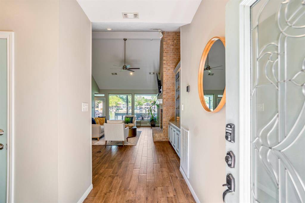 Easy breezy views of the lake from the moment you enter, with wood look tiled flooring throughout the downstairs area.
