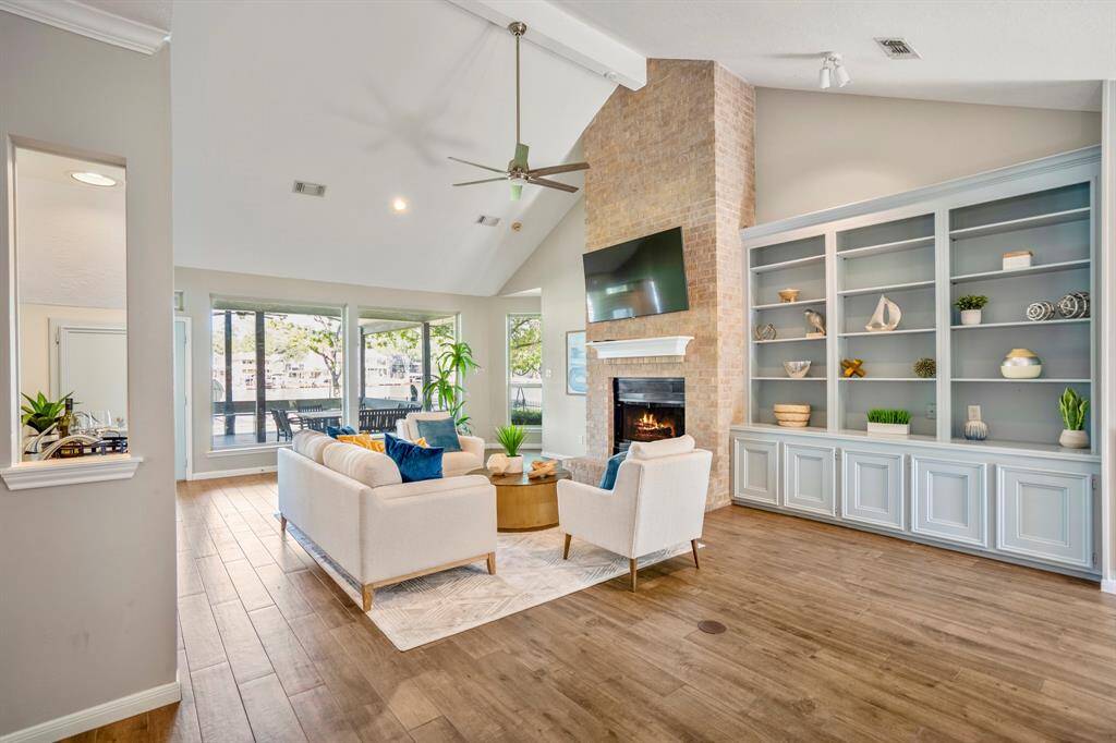 A cool-water blue tone on the built-in wall unit with white trim for contrast, creates a fun feel for this relaxing lounge with laid-back style.
