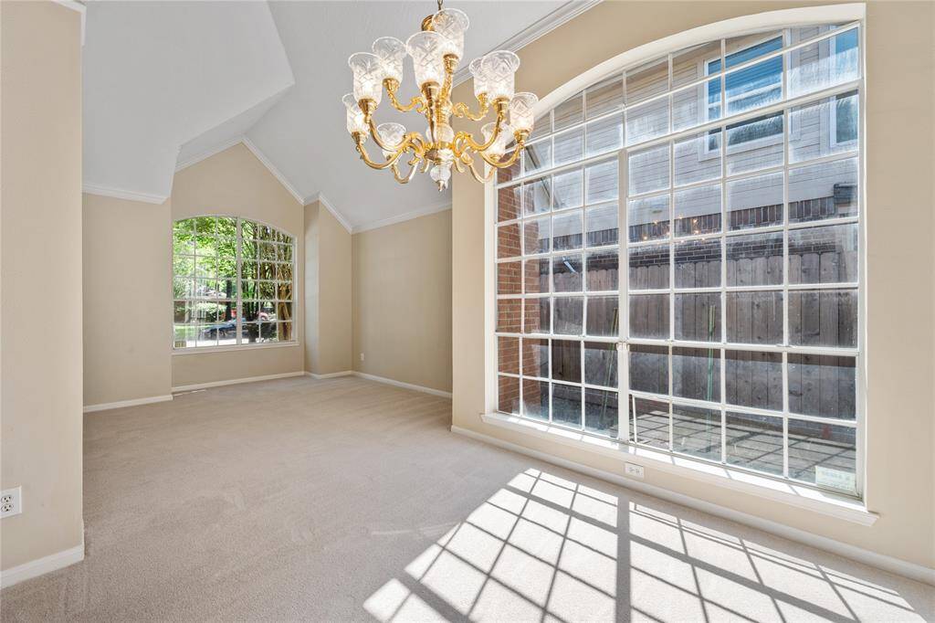Bright and spacious dining area with high ceilings and large arched windows, allowing plenty of natural light.
