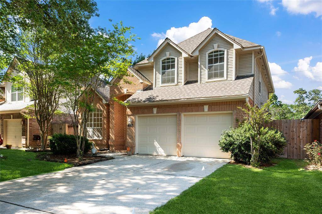 This is a charming two-story home with a brick and siding exterior, featuring a double garage.