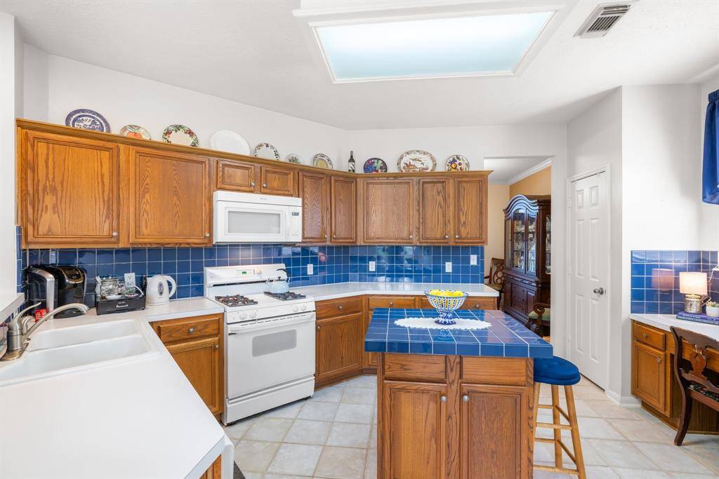 KITCHEN - What a cheerful kitchen!  Nice and bright kitchen is the heart of the home.  Lots of cabinet space.