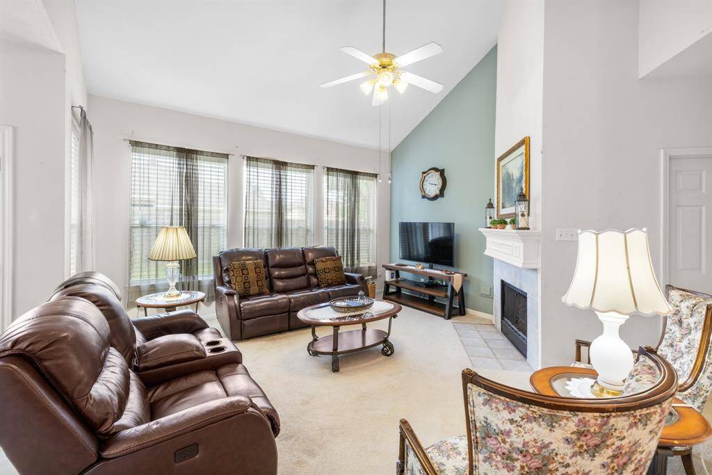 FAMILY ROOM - Wall of windows across the back of the room help let the sunlight in and provide views to the back yard.
