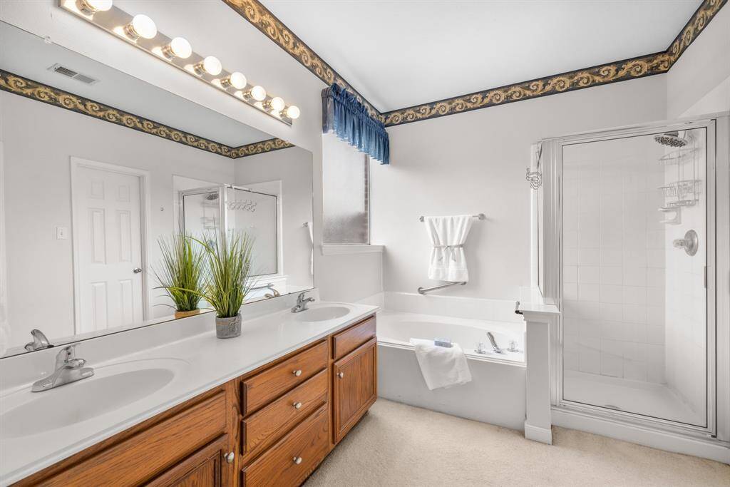 PRIMARY BATHROOM - Separate tub & shower.  Vanity area has 2 sinks and plenty of storage space.  There is a toilet area and & walk-in closet.