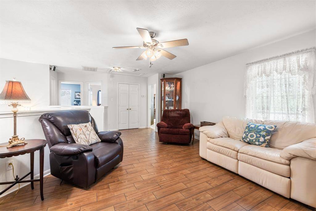 UPSTAIRS GAME ROOM OR LIVING AREA - This room has wood-look tile flooring & ceiling fan.