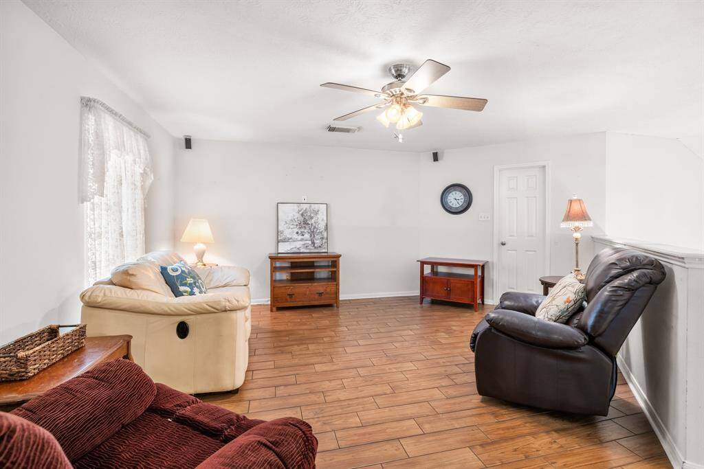 UPSTAIRS GAME ROOM OR LIVNG AREA - There is a large walk-in closet to the right of the clock.  There is a TV bracket that will remain behind the painting.