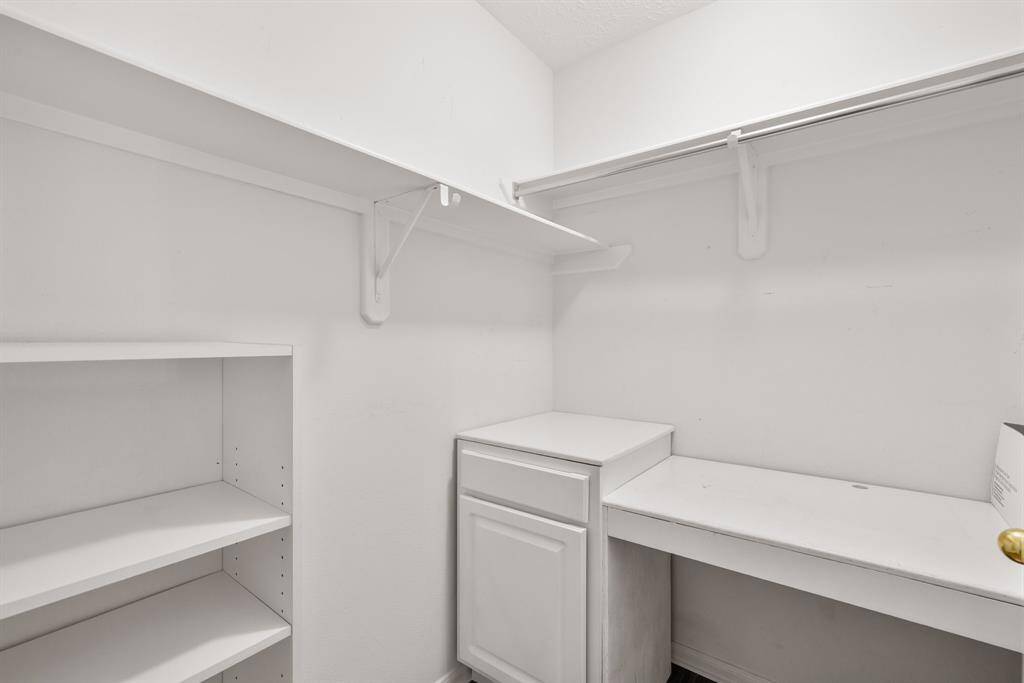 UPSTAIRS CLOSET - This closet in the game room has built-in desk and a bookshelf.