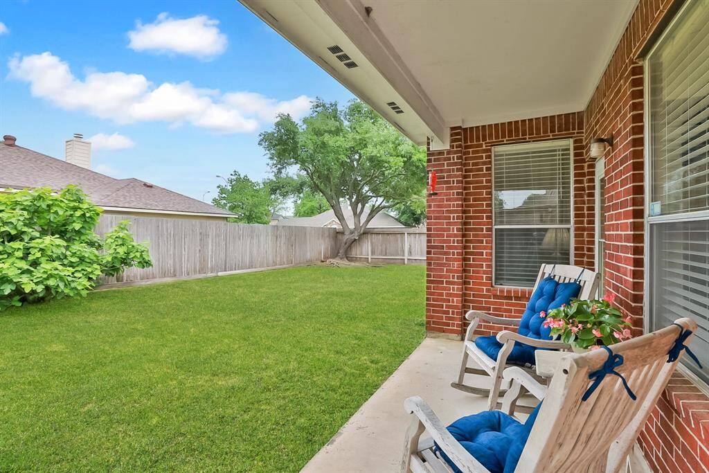 BACK YARD - Covered patio is just the right size to sit and enjoy the outdoors.  Mature fig tree in the back yard.