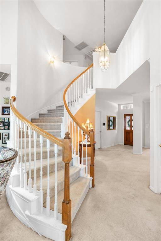 STAIRCASE -Beautiful spiral staircase is a focal point from the family room.
