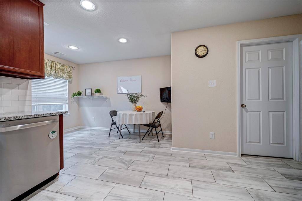 A large window above the sink provides natural light, creating a warm and inviting space.