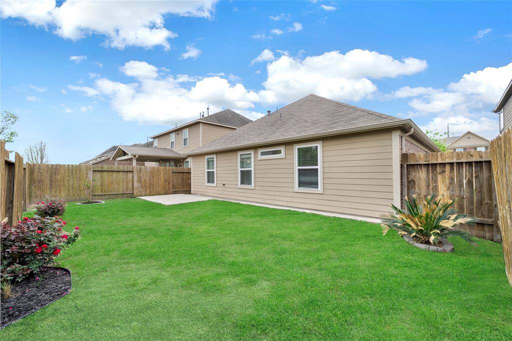 Lush green grass offering a private and inviting outdoor space for relaxation or entertainment.