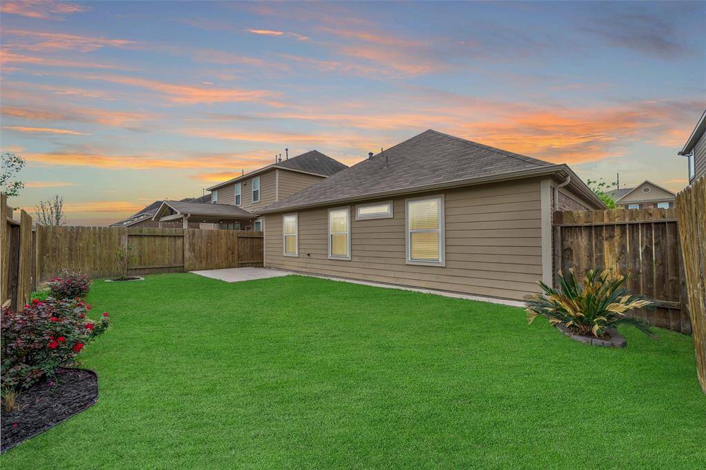 A well-maintained backyard with a lush green lawn. Perfect for outdoor relaxation and activities.