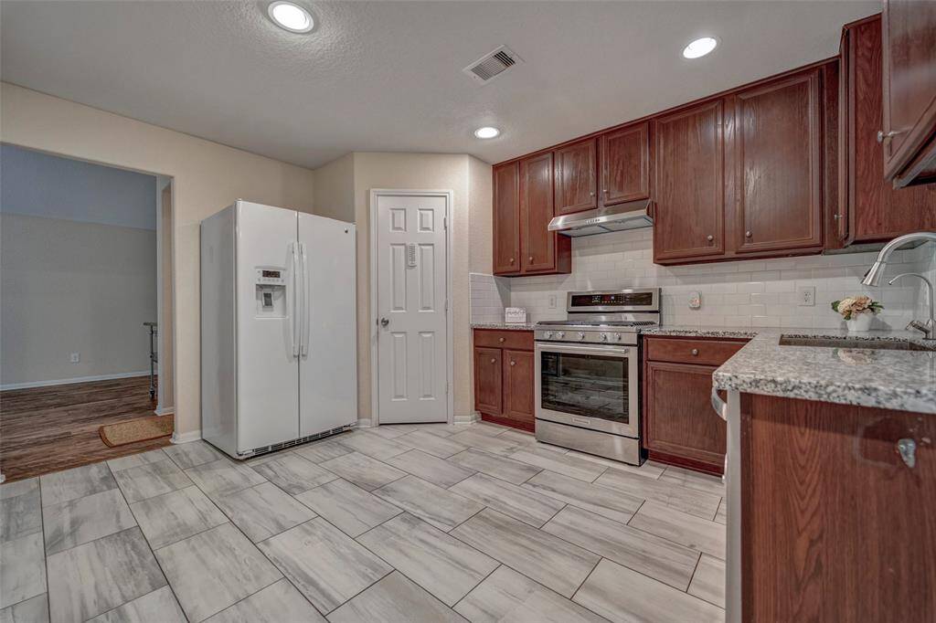 Granite countertops, and tile flooring, creating a modern and functional space.