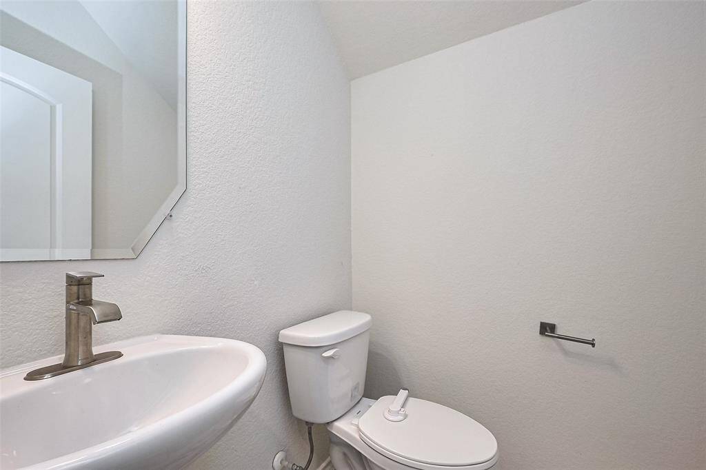 Compact and functional, the half bath features clean lines and thoughtful design, offering convenience with all the essentials.