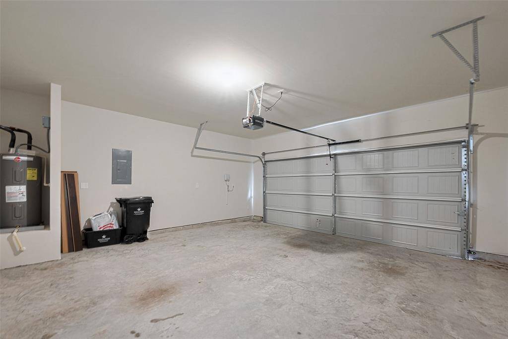 The garage provides a clean and roomy interior with an automatic opener, offering secure parking or additional storage space with plenty of versatility.