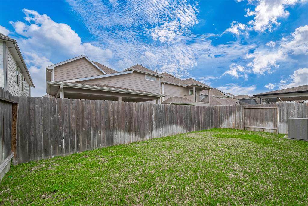 A wide expanse of lush grass fills the fenced backyard, offering plenty of room to play, unwind, or landscape to your liking.