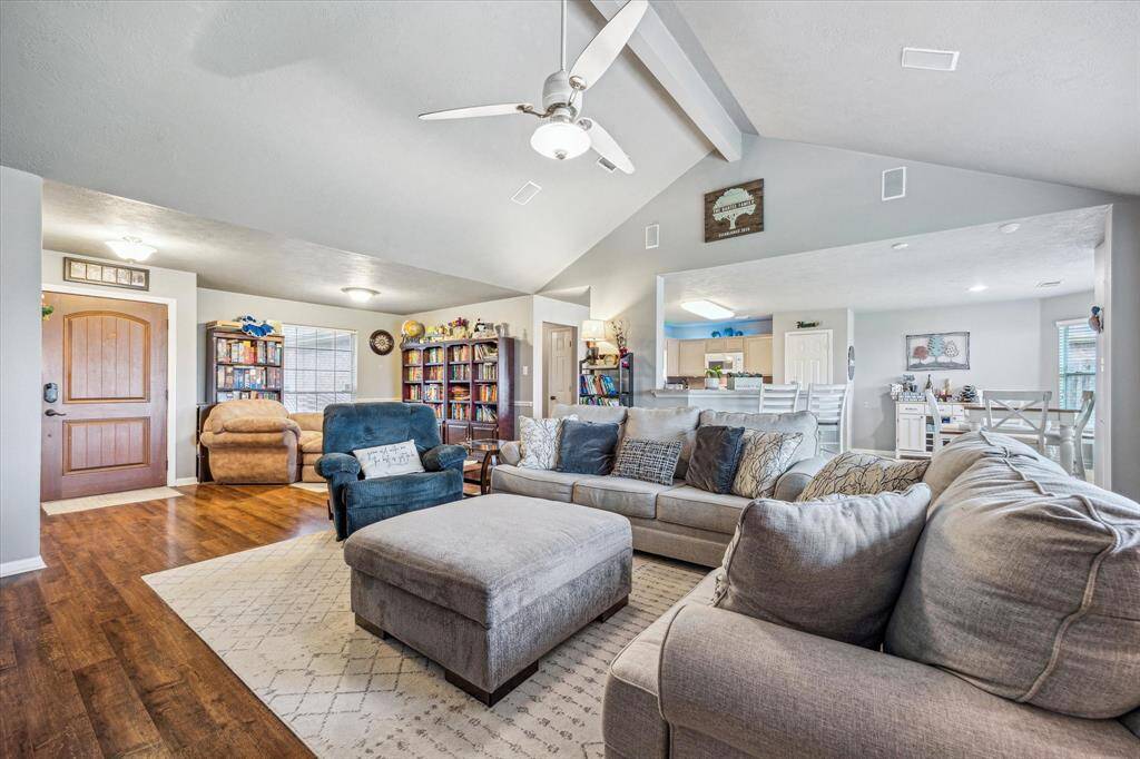 Family room with high arching ceilings with views into the kitchen and dining areas.