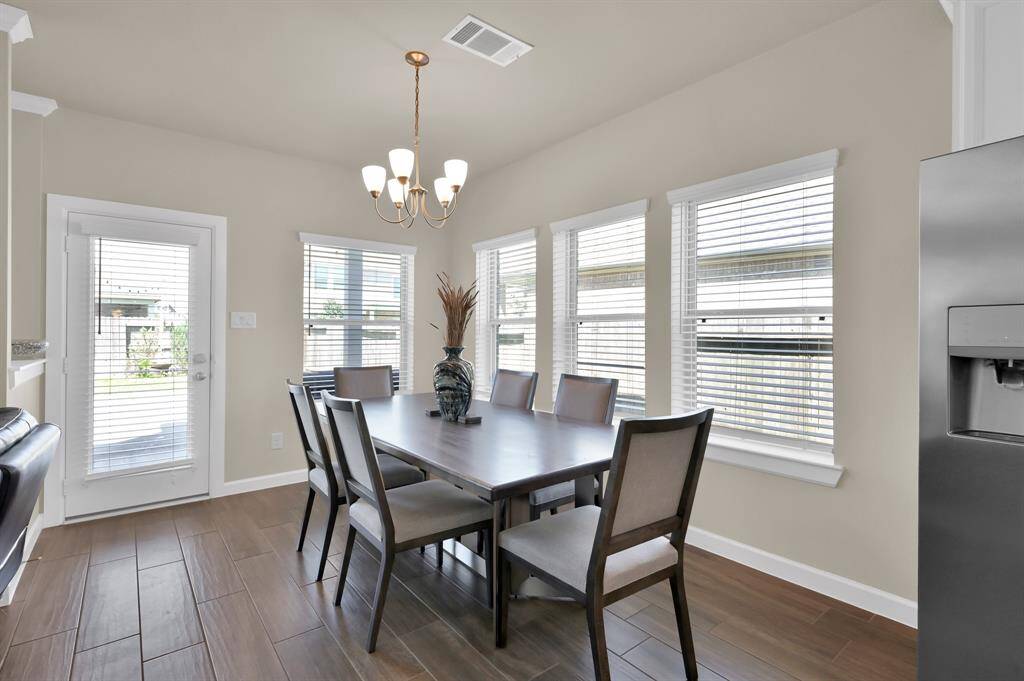 Surrounded by windows, this dining room provides the perfect setting for quick daily meals or lavish dinner party gatherings.