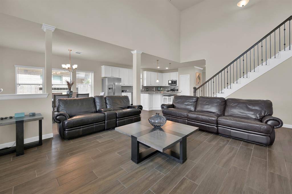 Another view highlights the wrought iron spindle staircase with the rich warm banister. Every detail counts!
