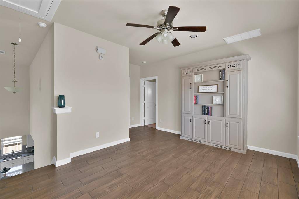 The tile floors continues up the stairs and into the common areas upstairs.  The game room also includes a hidden Murphy bed in the book shelf!