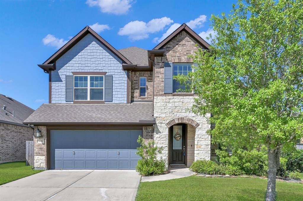 The "shake" style siding, brick exterior, and warm rectangular stone captures your attention immediately and stands out amongst the neighboring homes.