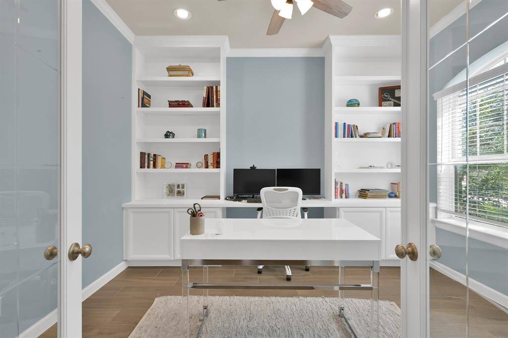 At the front of the home you'll find your relaxed home office, with efficient built-in cabinetry and abundant natural light accessible through beautiful etched glass French doors. Plenty of space for two work stations.