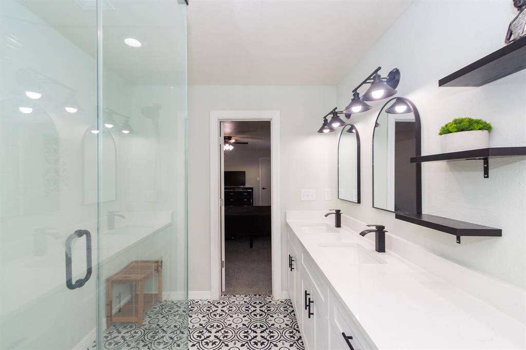 Alternate view of the bathroom into the primary bedroom.