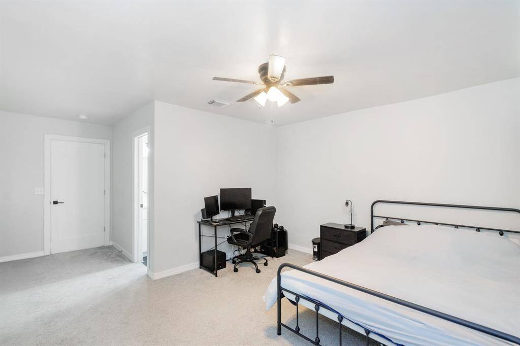 Well-appointed secondary bedroom with a private ensuite bathroom, conveniently located at the front of the home - ideal for guests.