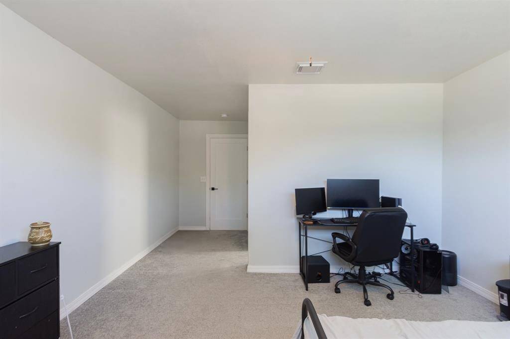 Spacious secondary bedroom measuring 19 x 13, offering plenty of room for versatile furniture arrangements and additional living space.