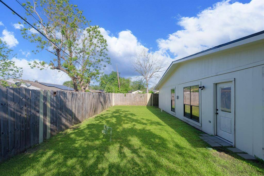 This backyard perfect for entertaining or adding a cozy patio area—offering plenty of room to customize your outdoor oasis.