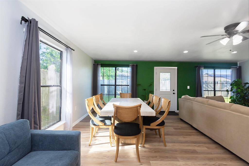 Well-lit dining area with large windows that fill the space with natural light, conveniently located next to the living area for easy flow and entertaining.