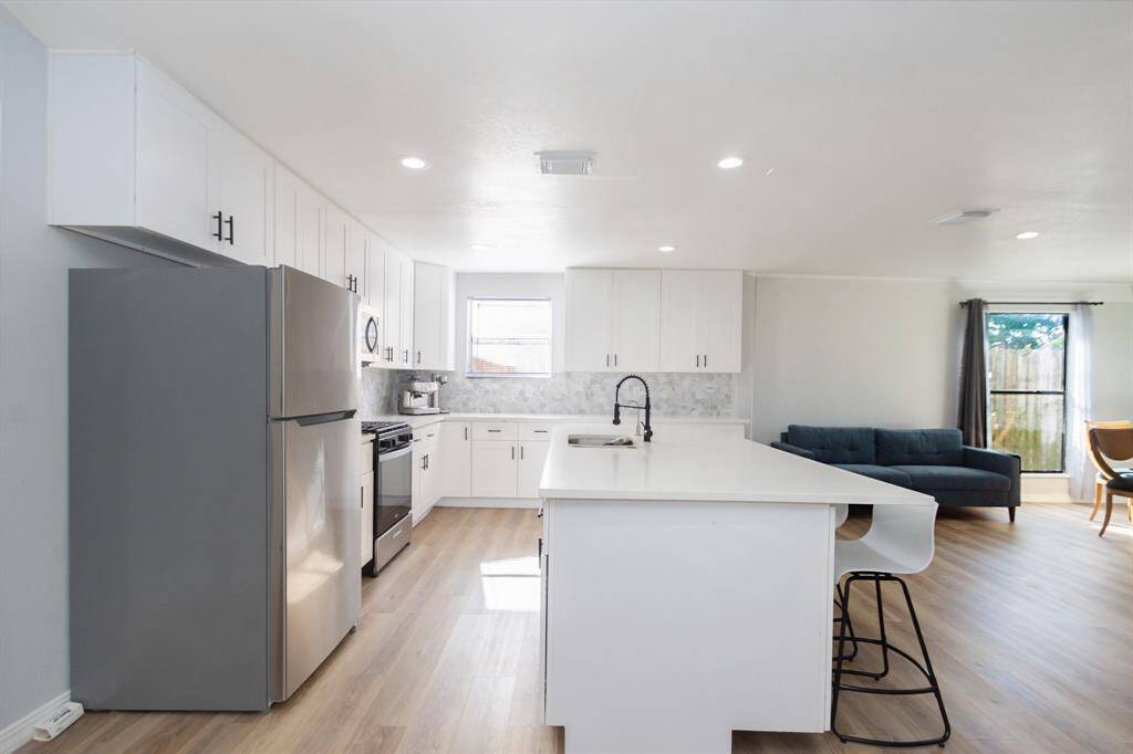 Light-filled kitchen featuring an impressive 8-foot quartz island—perfect for cooking, casual dining, and effortless entertaining.