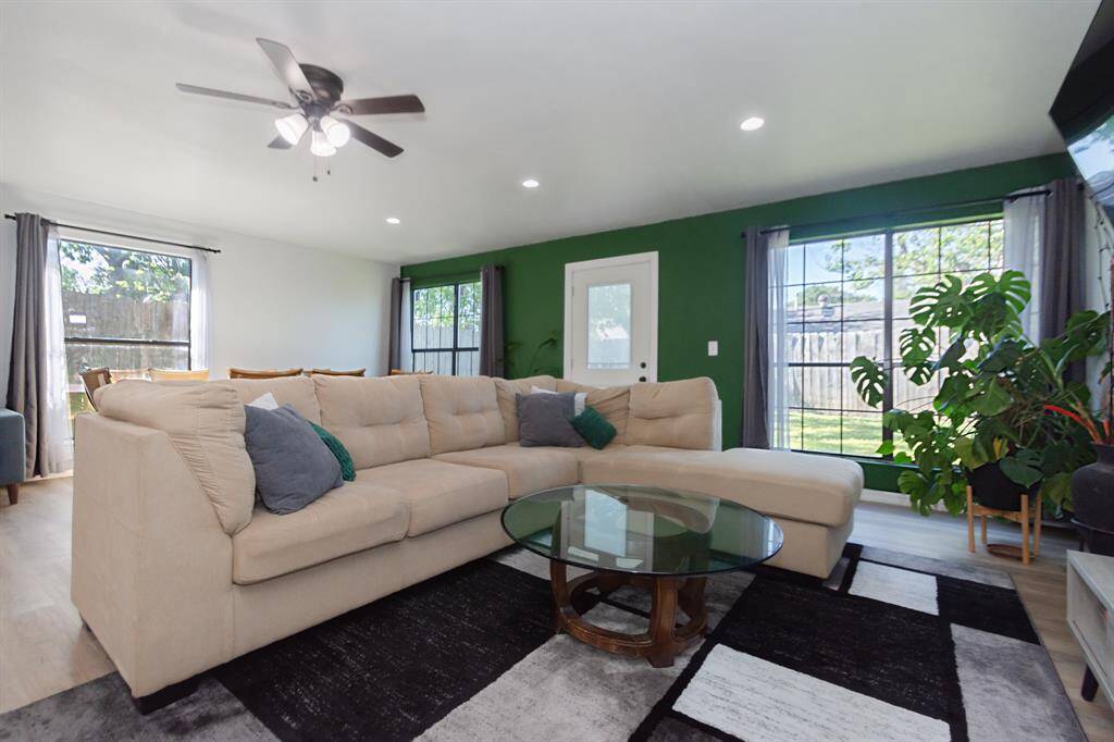 Modern living area surrounded by large windows, creating a warm and inviting atmosphere for your family and friends.