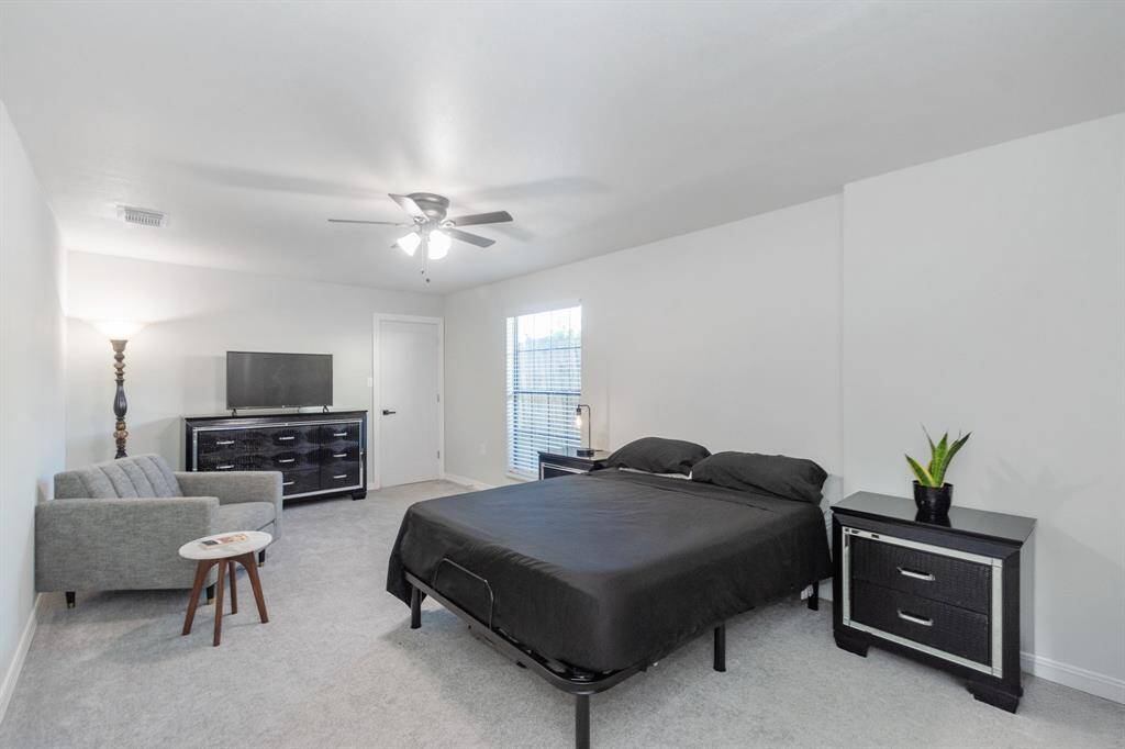 Spacious primary bedroom featuring a walk-in closet, ensuite bathroom, and plenty of room for a cozy seating area—your perfect private retreat.