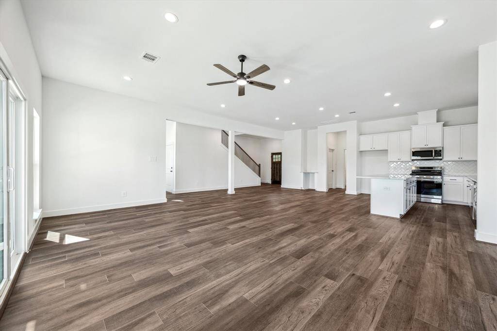 An airy atmosphere throughout the living area with large windows full of natural light.
