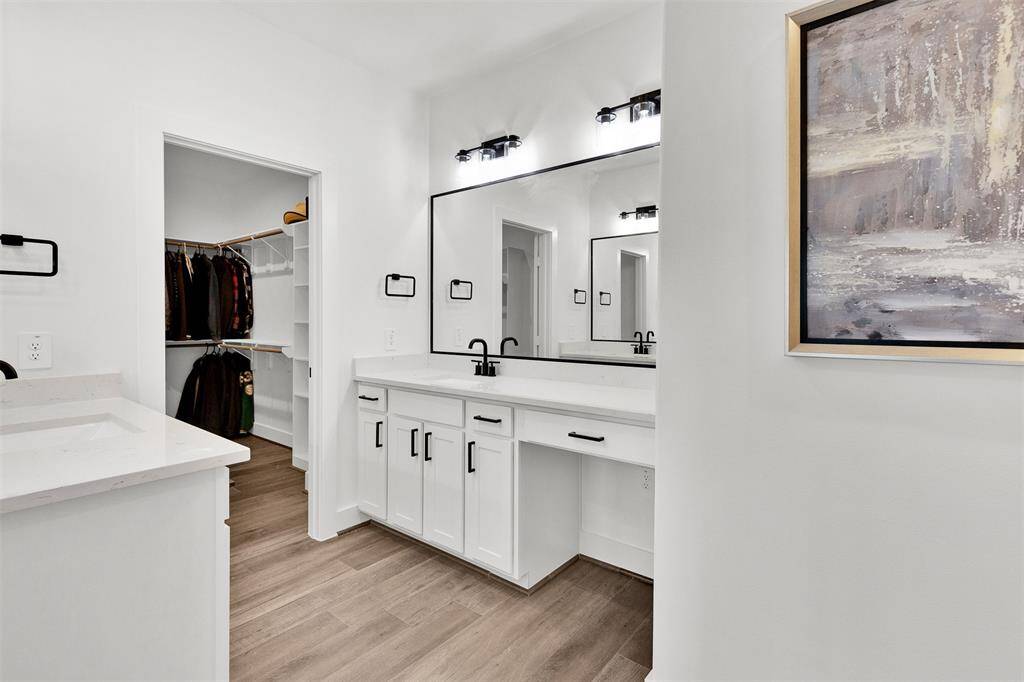 Dual vanities with quartz countertops.