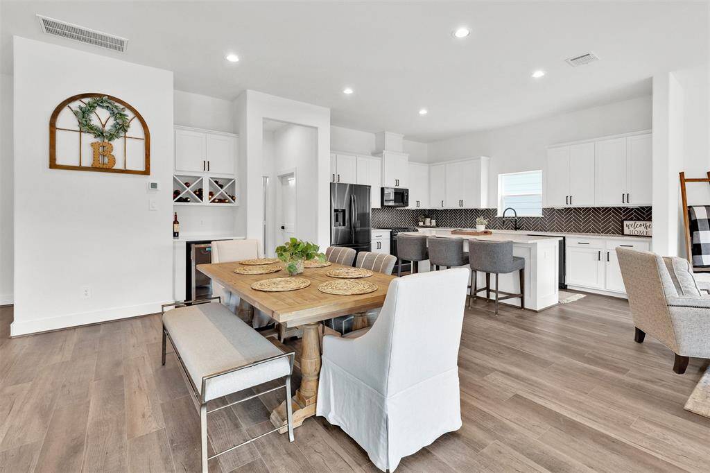 Current kitchen with a big island space with additional seating.