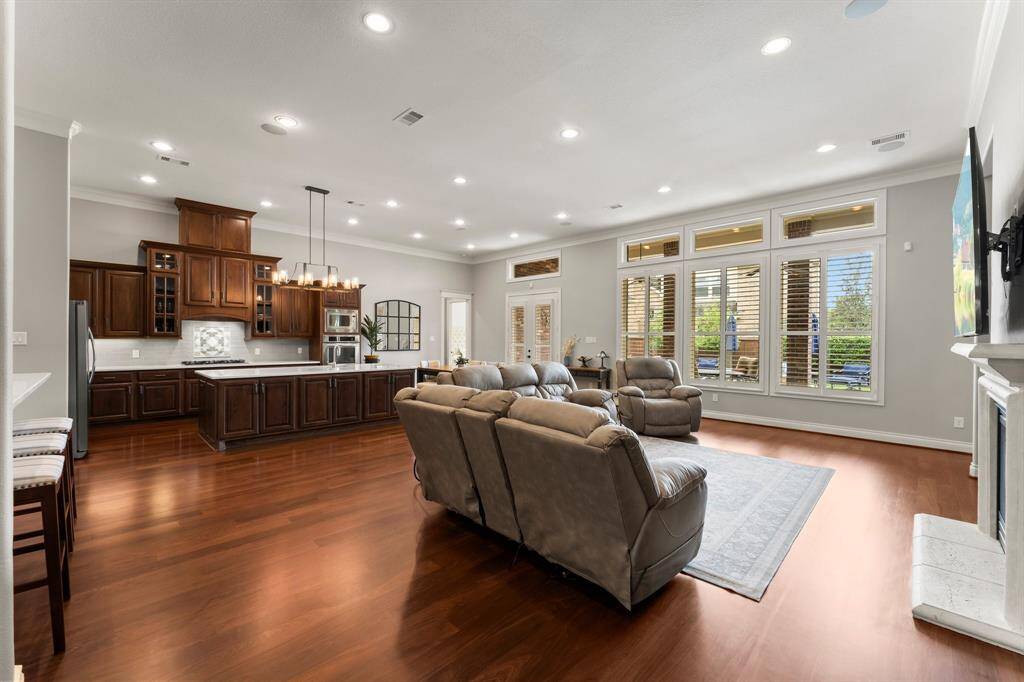 Beautiful wood floors, cased windows, plantation shutters, and a stunning drum chandelier