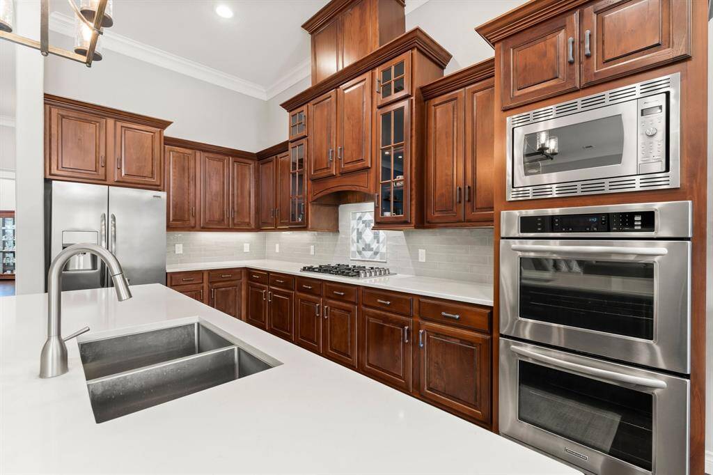 This kitchen offers an updated cooktop, sink, dishwasher, and countertops!