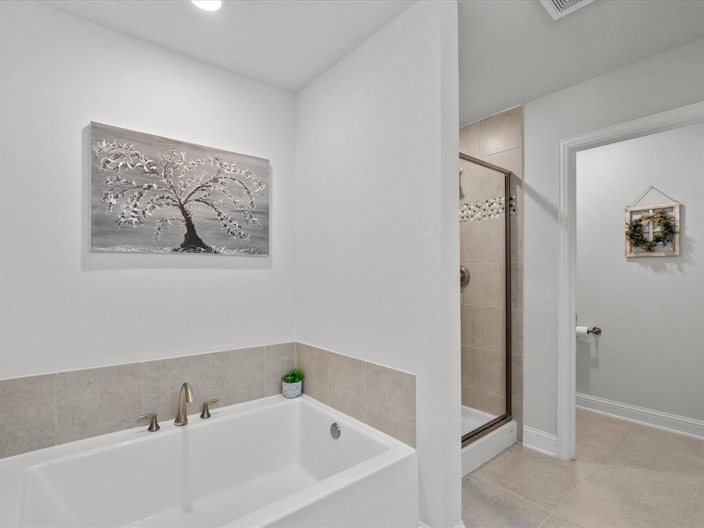 Enjoy the luxury of a primary bath with a soaking tub and a separate walk-in shower