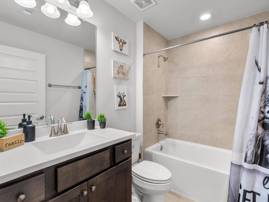 Secondary bath featuring a spacious tub, perfect for relaxation.