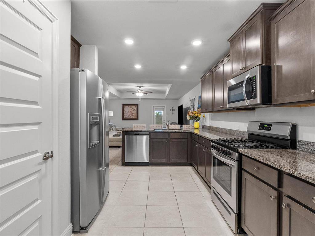 Enjoy a seamless flow with this open kitchen that connects effortlessly to the living areas