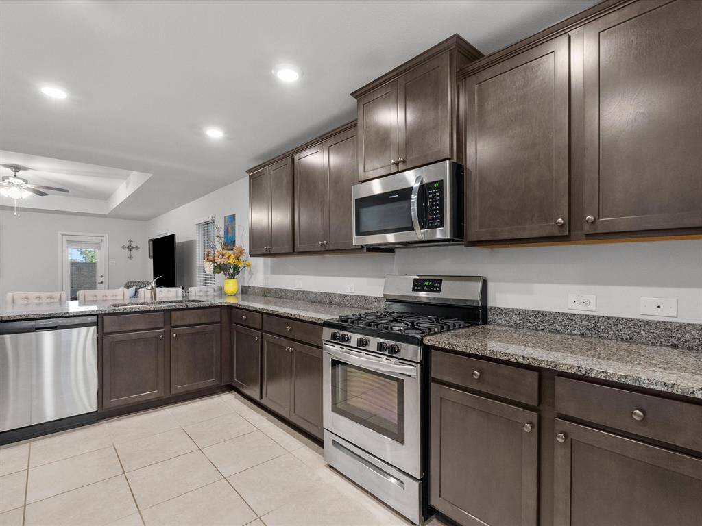 The kitchen features plenty of counter space, complemented by elegant granite surfaces.